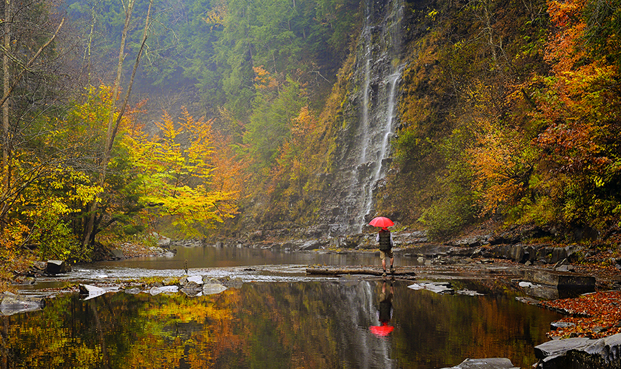 Man Hiking Along Waterfall